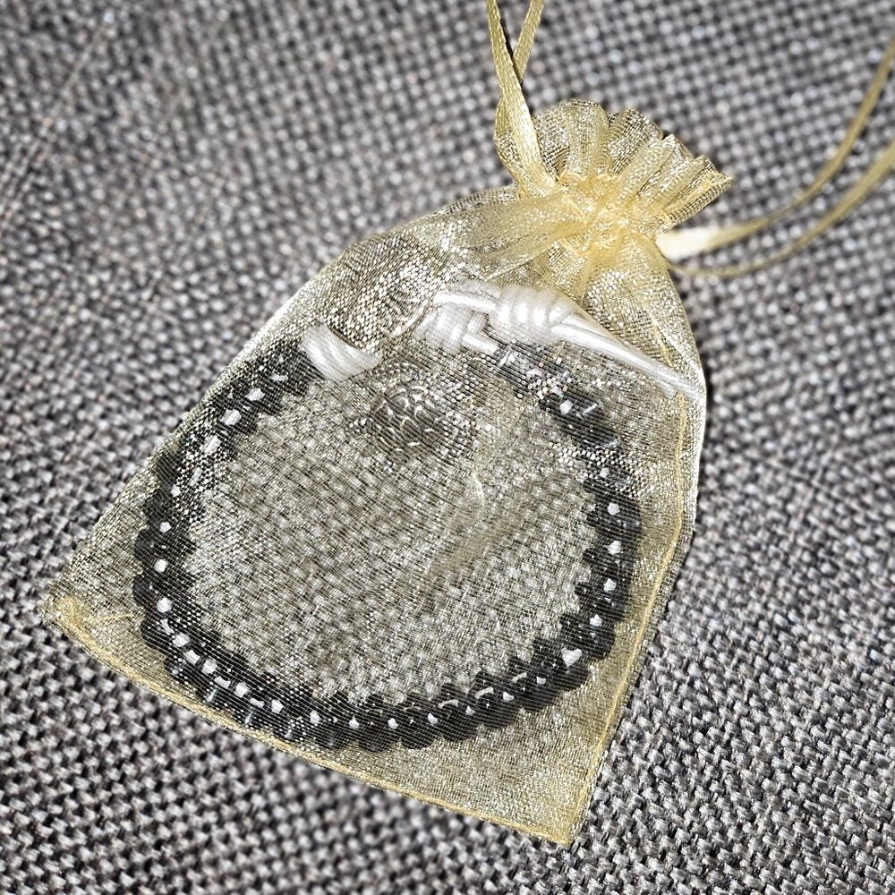Bracelet with Rhinestones Set in Black Beads with White Tie and Turtle Charm